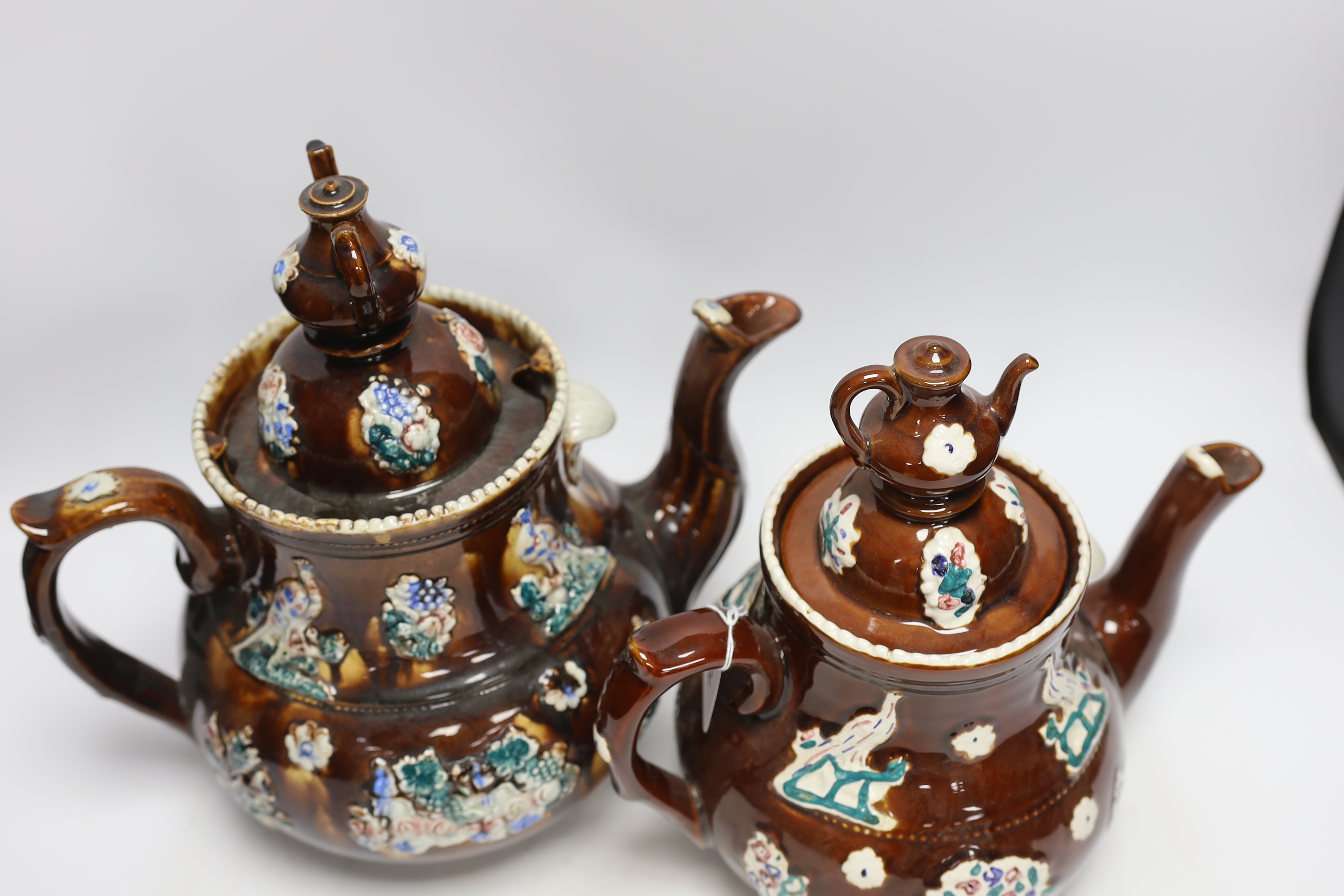 A late 19th century Measham barge ware teapot and cover, 31.5cm high, together with a reproduction teapot in the same style